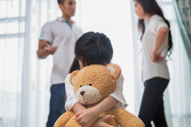 sad-child-listening-to-parents-argue-during-their-divorce