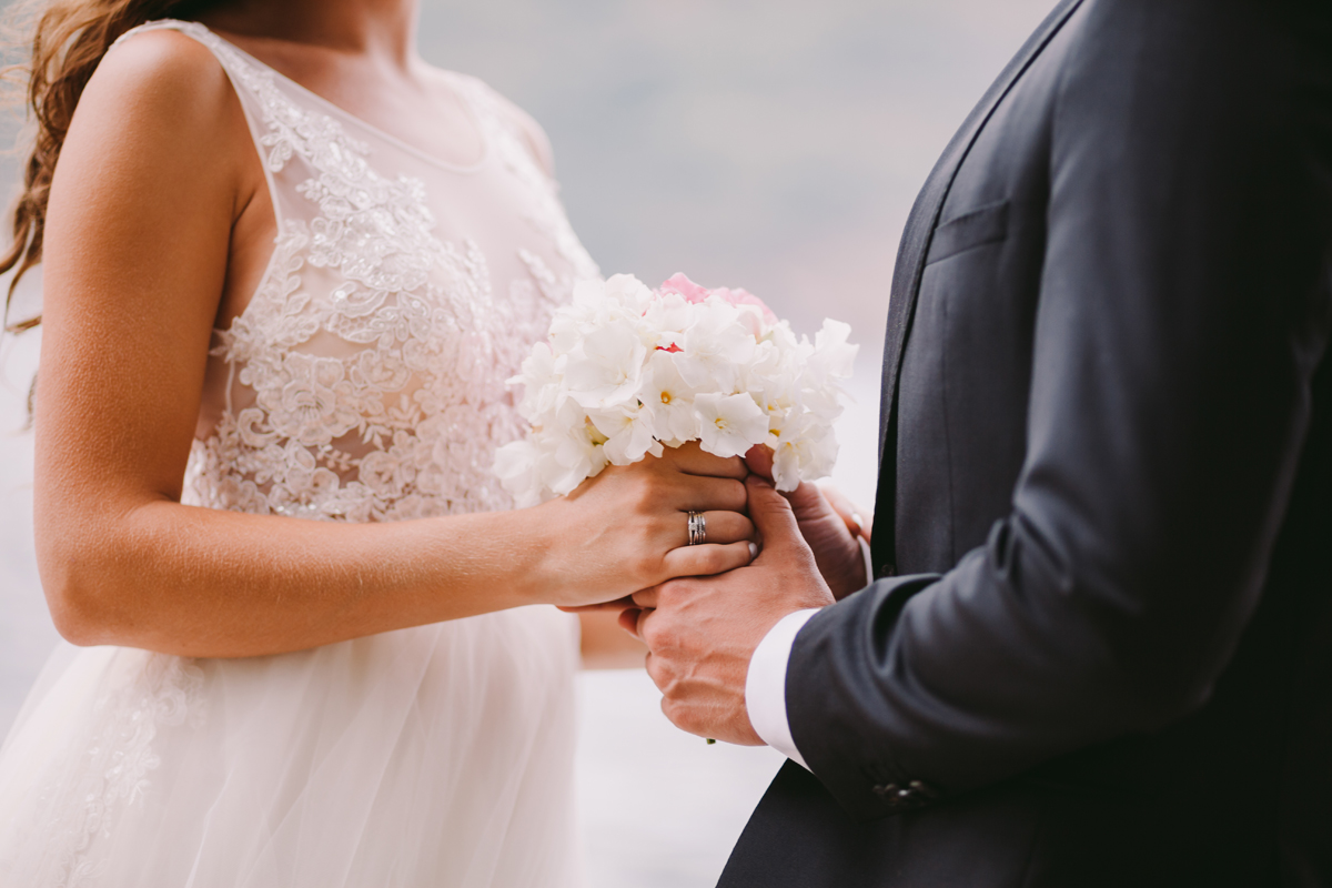 newlyweds holding wedding bouquet