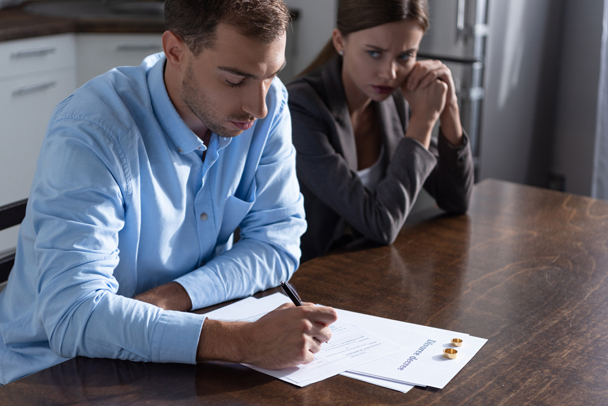 couple with divorce documents at table at home