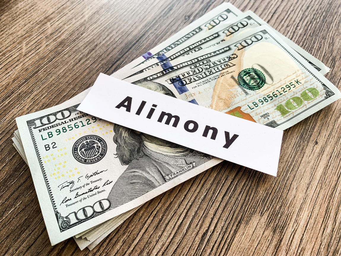 Payments alimony. Pile Dollars with sign alimony and money. Divorce and separation concept